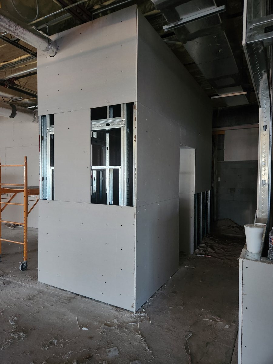Framed and boarded office enclosure inside an active warehouse