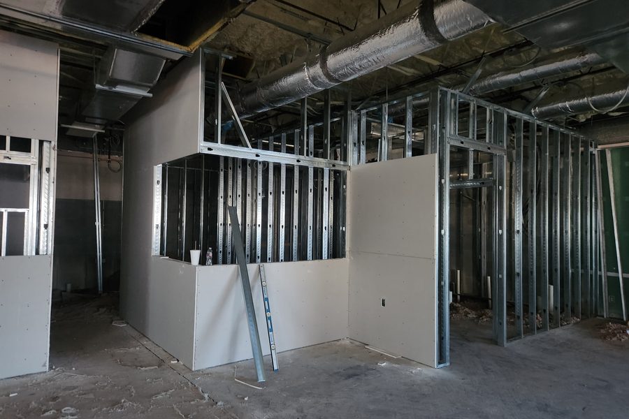 Metal framing and drywall going up in a commercial shell